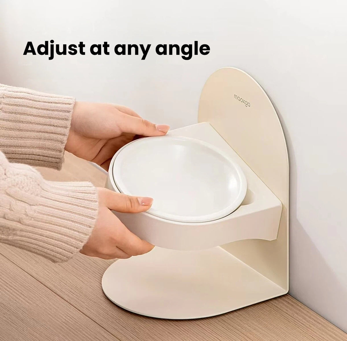 Hands adjusting the tilt of the raised Miao Xiang Jia ceramic cat bowl
