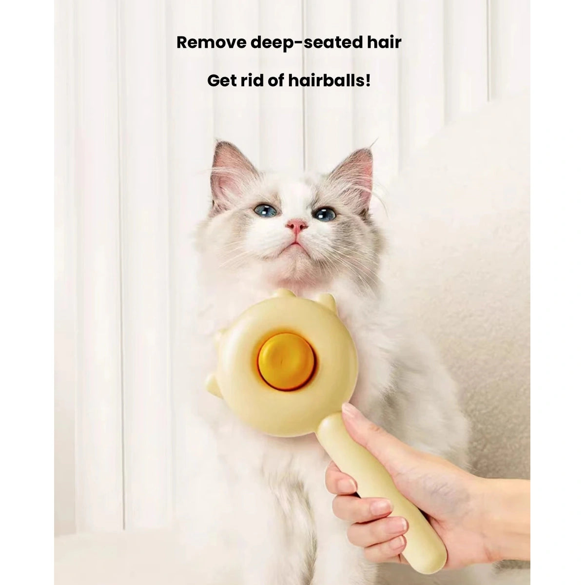Cat being brushed with the yellow grooming comb