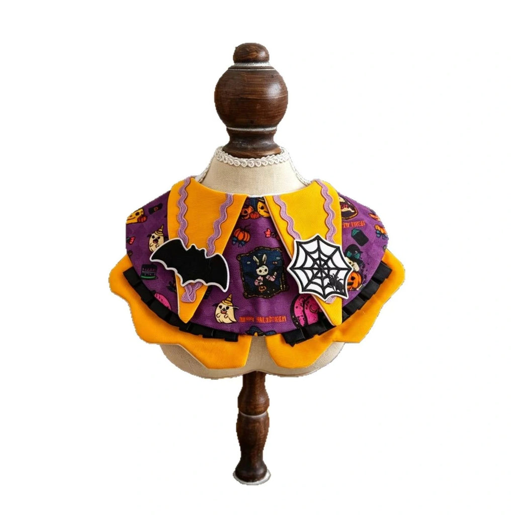 Pumpkin-themed pet bib costume on mannequin