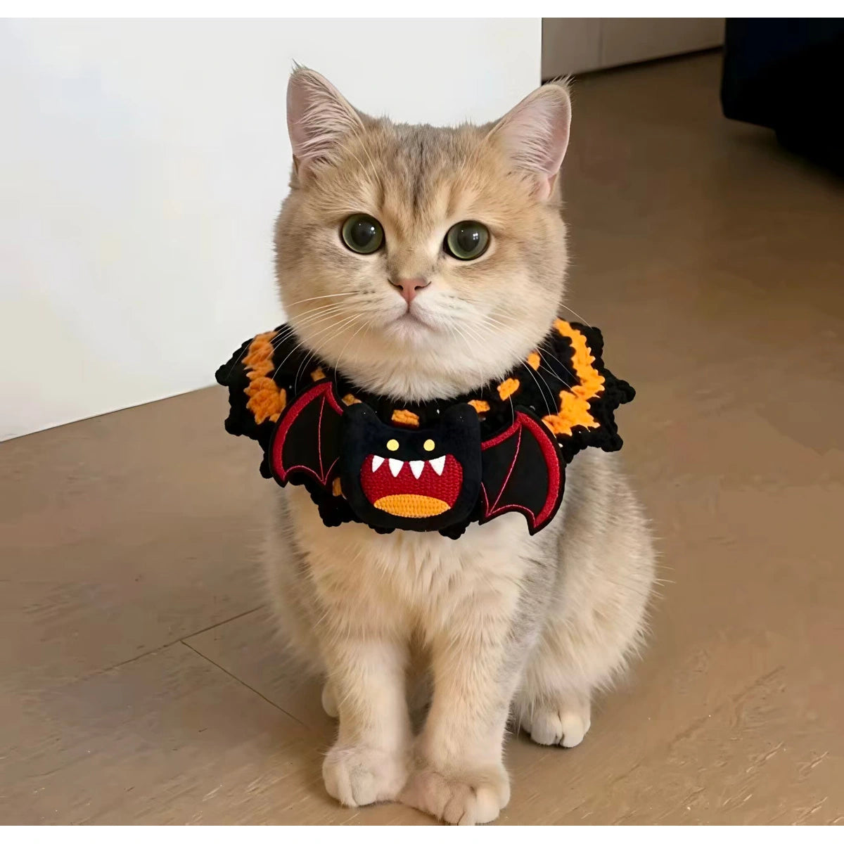 Cat wearing Halloween bandana collar indoors