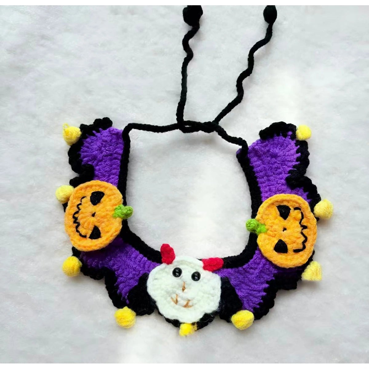 Pumpkin and ghost knit pet collar laid flat