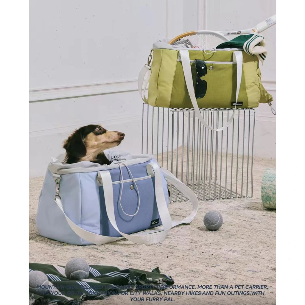 Blue and green UF pet carrier bags shown in a room