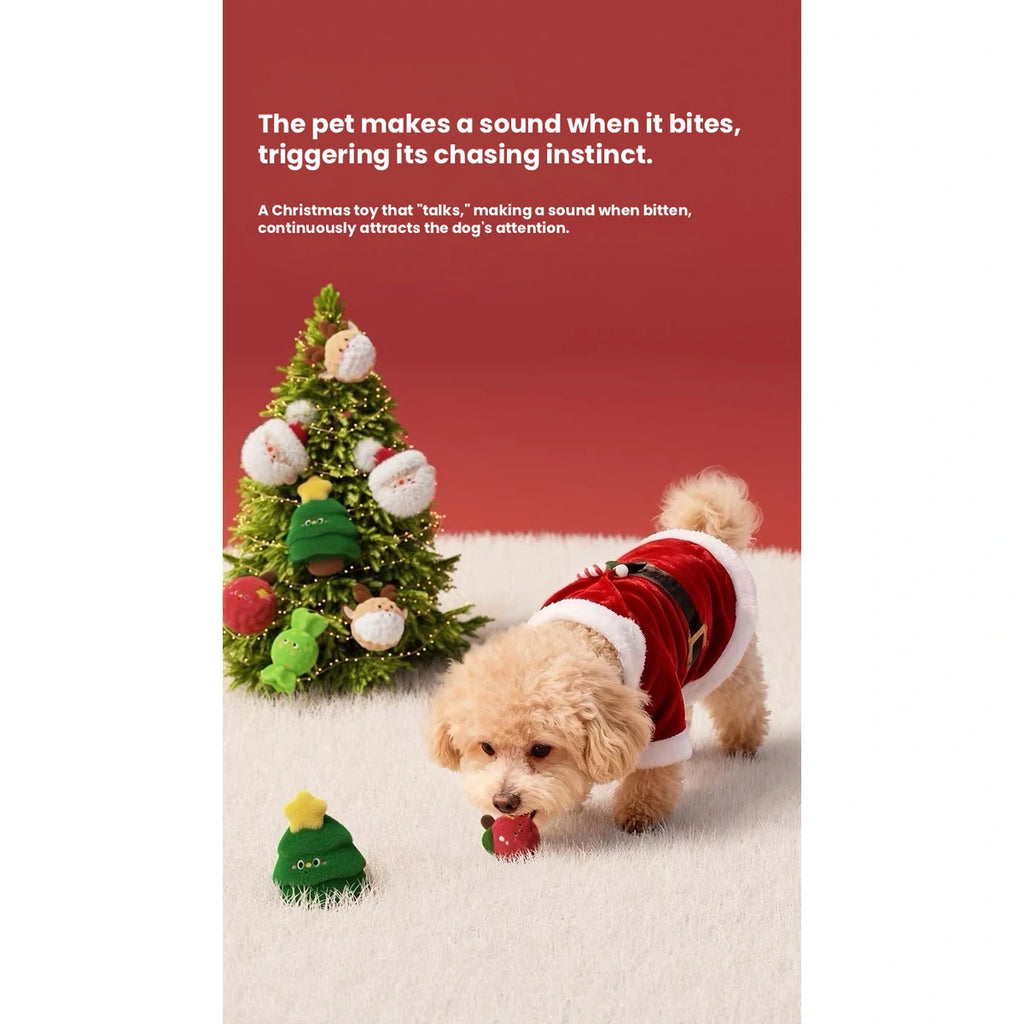 Dog playing beside a green Christmas plush toy