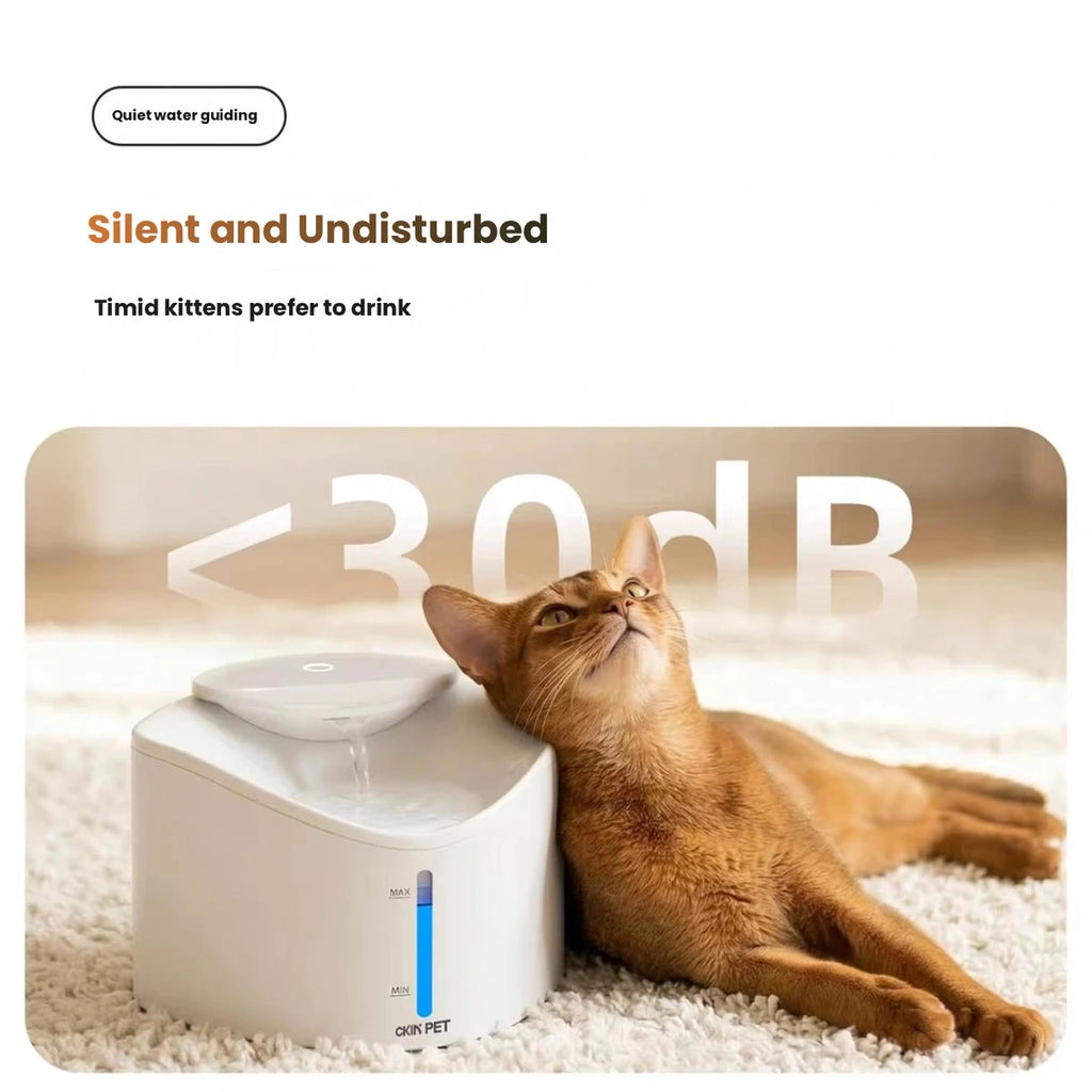 Cat resting beside white Ckin Pet fountain
