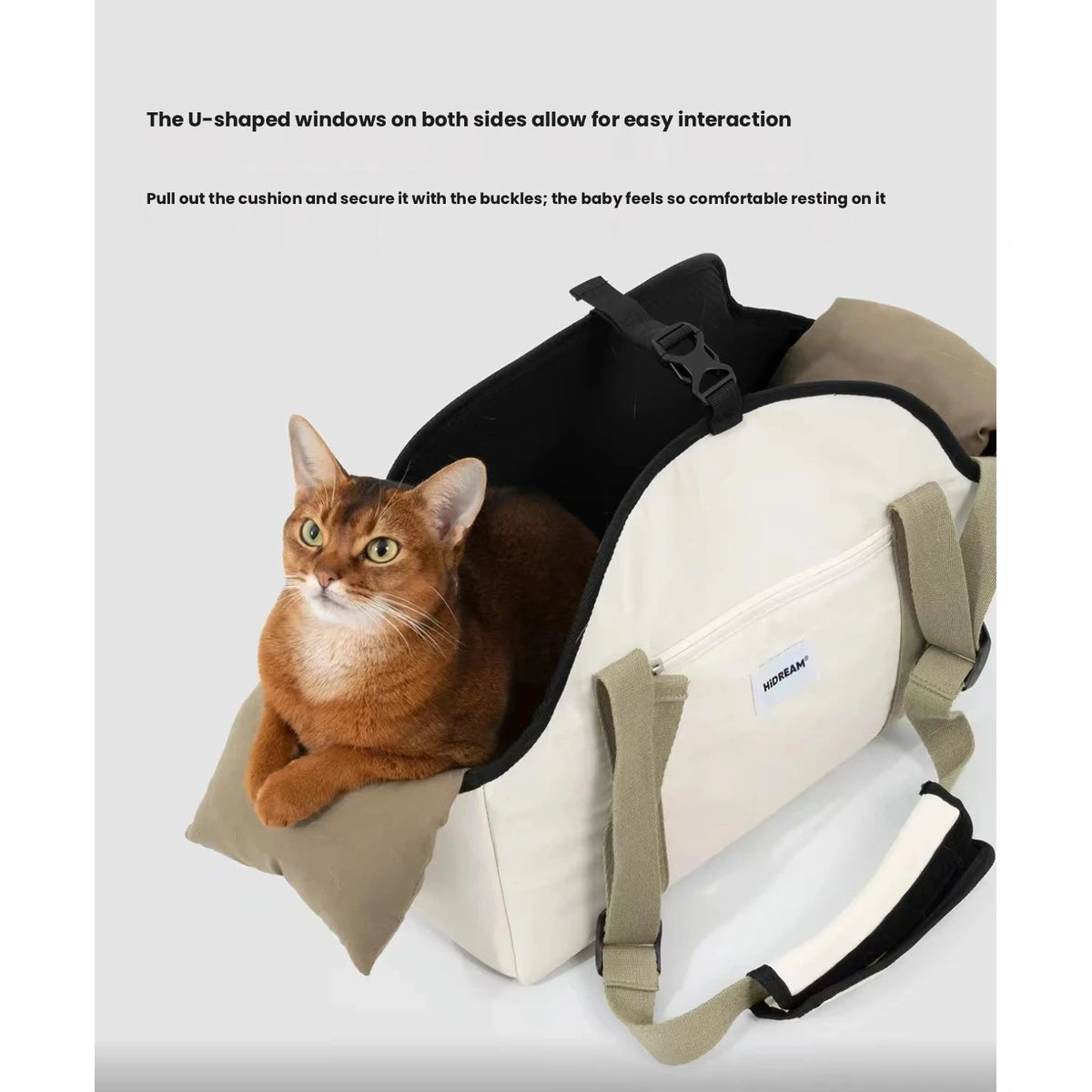 Cat looking out of the HiDREAM beige shoulder carrier