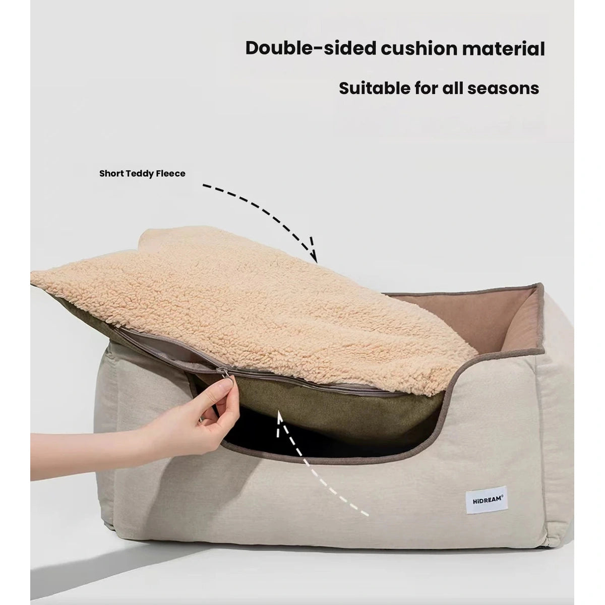 Hands lifting the reversible cushion from the HiDREAM pet bed