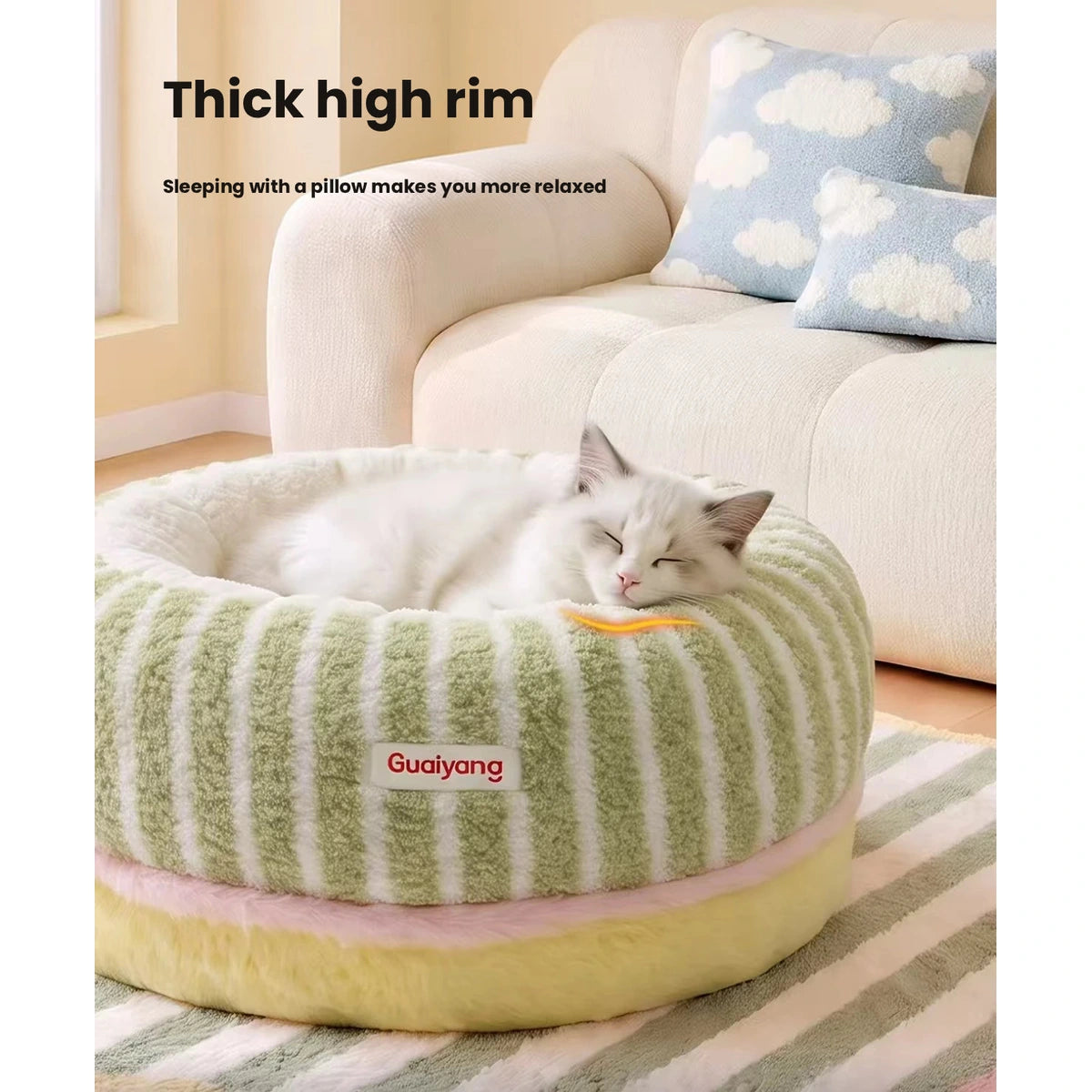 Cat resting against the raised plush rim of the green bed