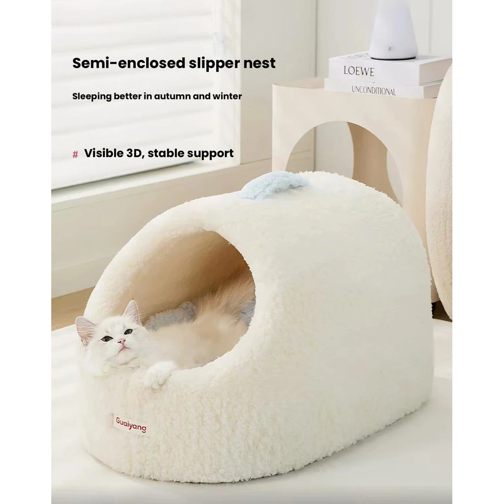 Cat inside the cream-coloured plush cave bed