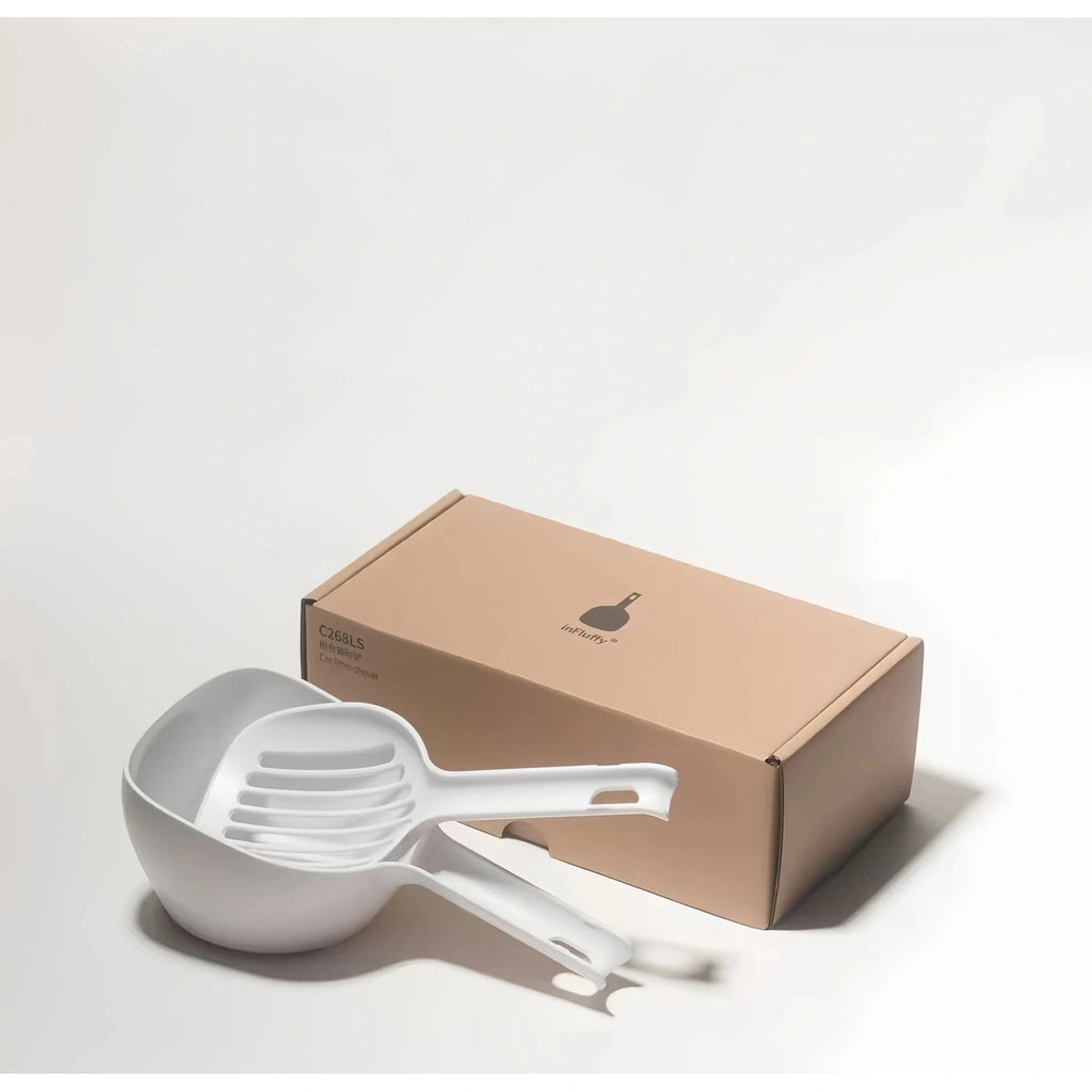 inFluffy litter scoop and holder beside their packaging