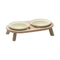 inFluffy wooden feeding stand holding two pale ceramic bowls