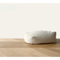inFluffy pale square pet bean bag pouf on a wooden floor