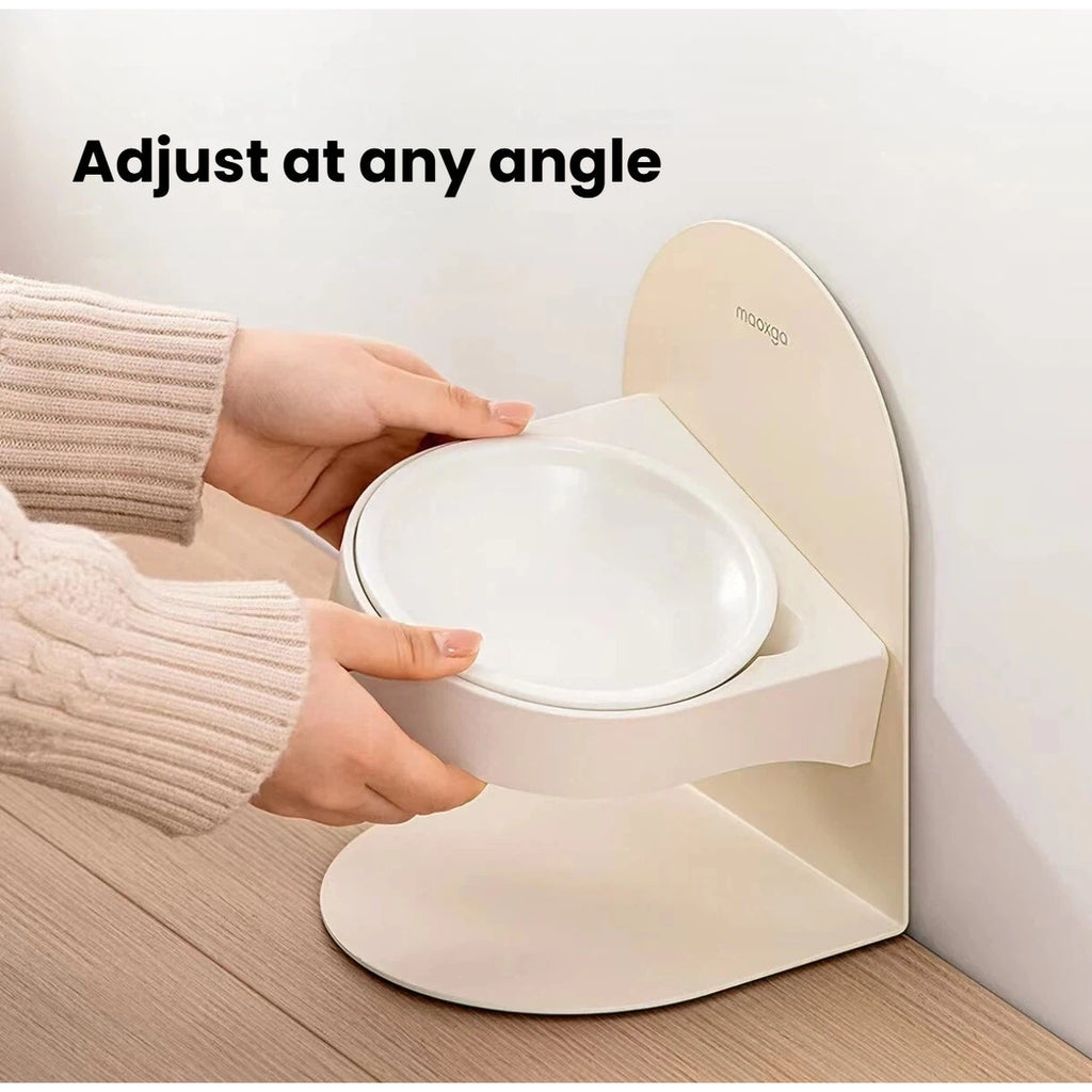 Hands adjusting the tilt of the raised Miao Xiang Jia ceramic cat bowl