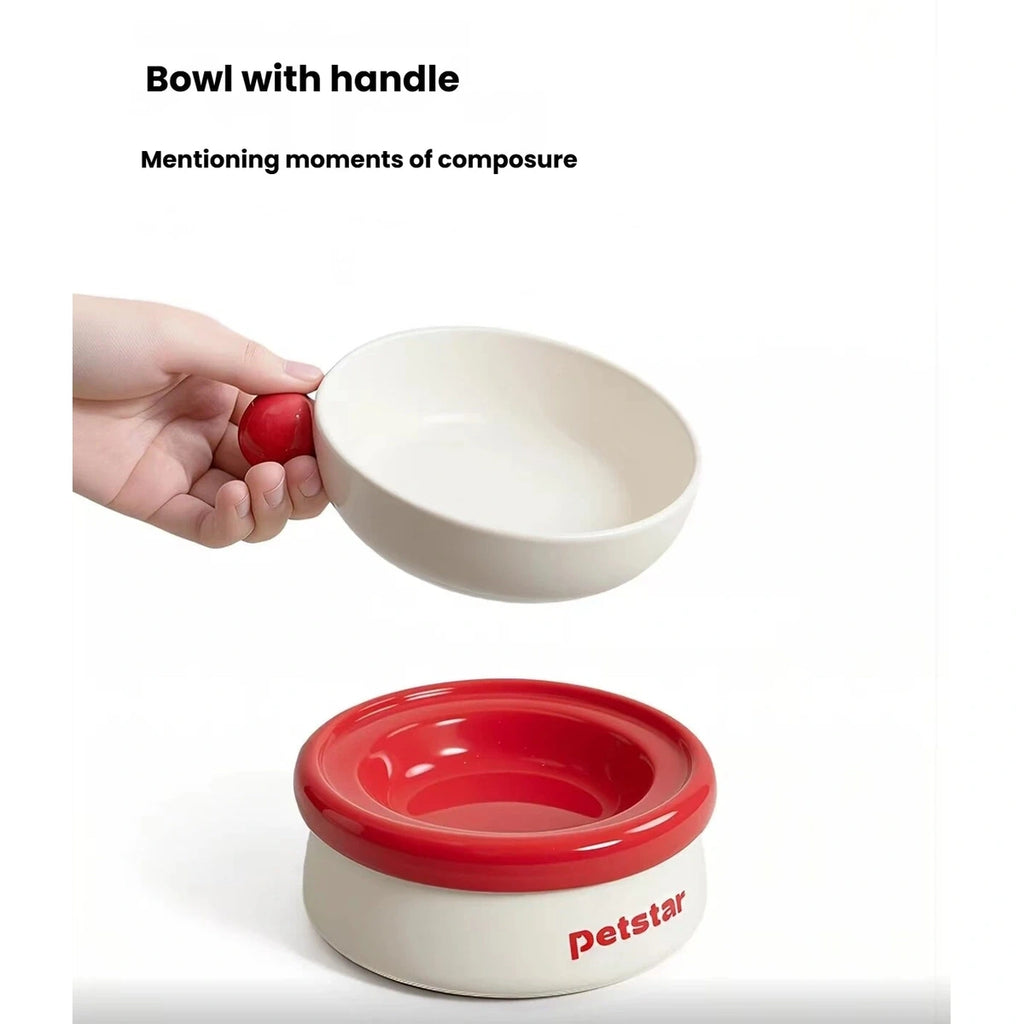 Hand lifting the handled upper bowl from the Petstar set