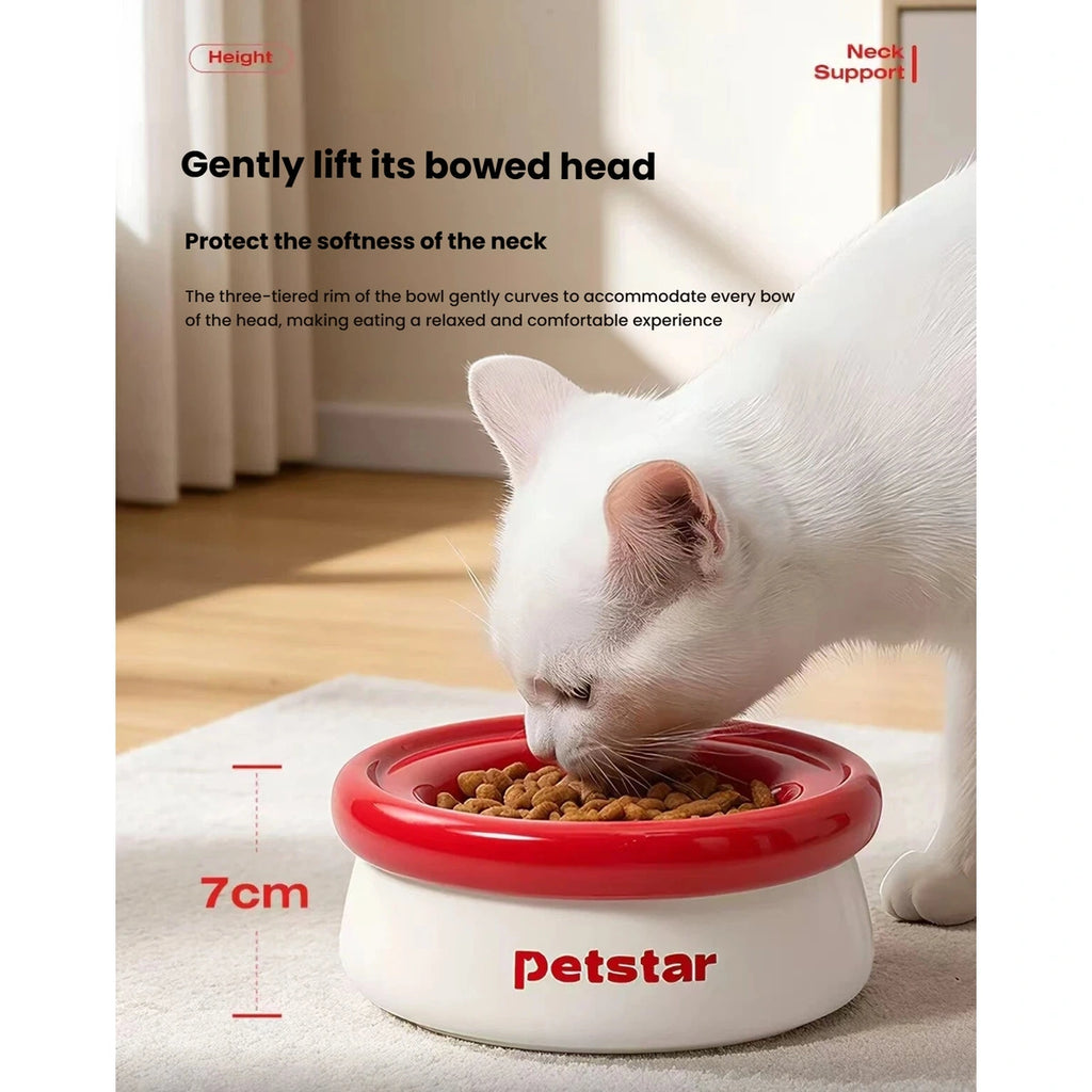Cat eating from the raised red and white Petstar feeding bowl
