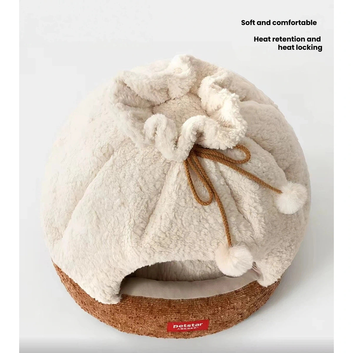 Top view of the Petstar cat cave’s gathered fabric and pom-pom decoration