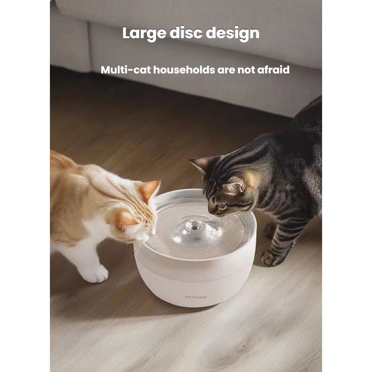 Two cats drinking from the round Petwant water fountain