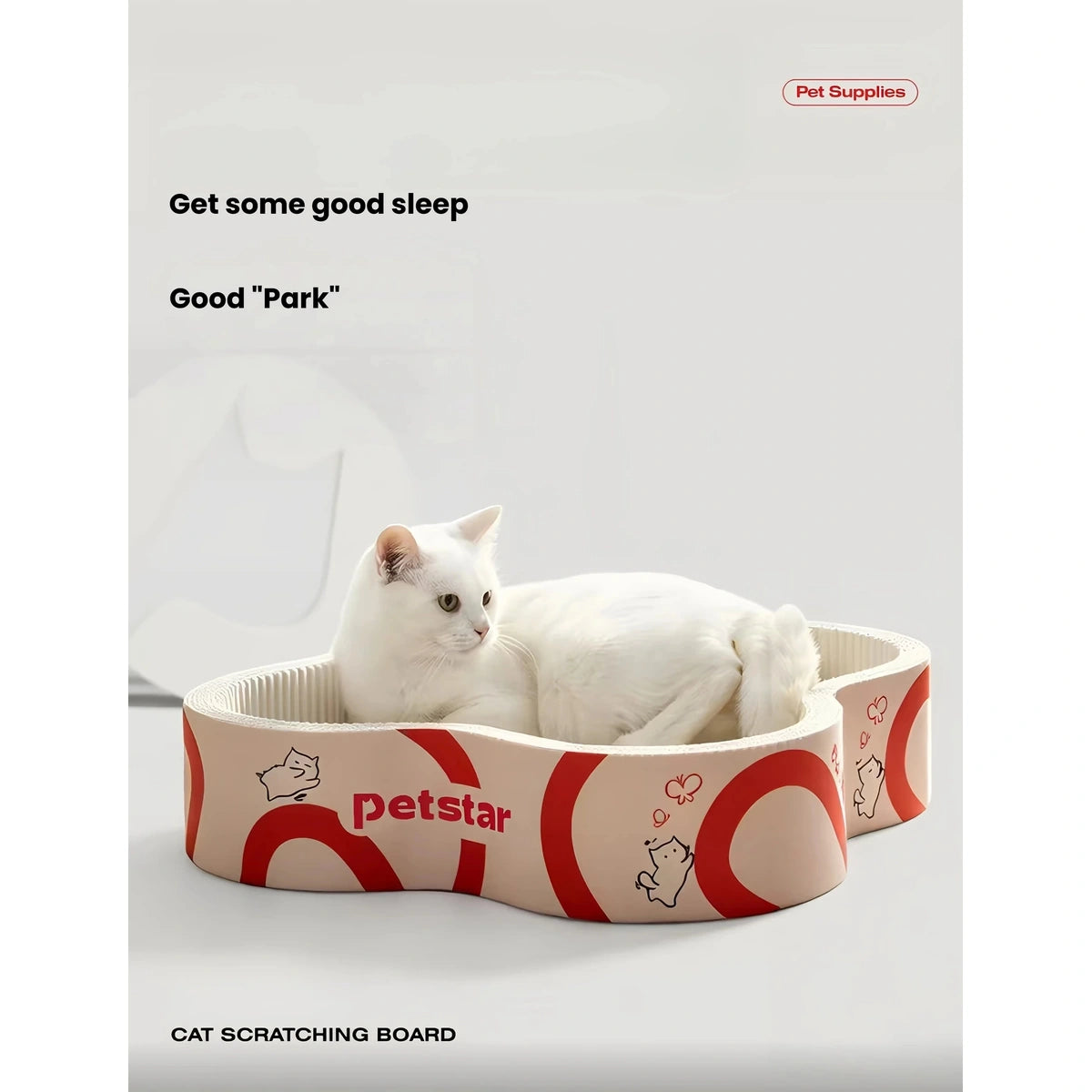White cat resting in a Petstar flower-shaped cardboard scratcher bed
