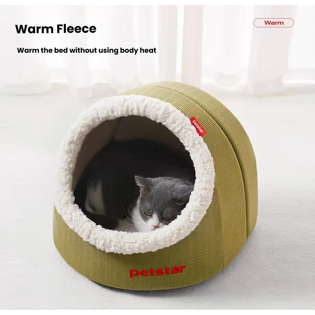 Grey and white cat curled inside a green Petstar cave bed