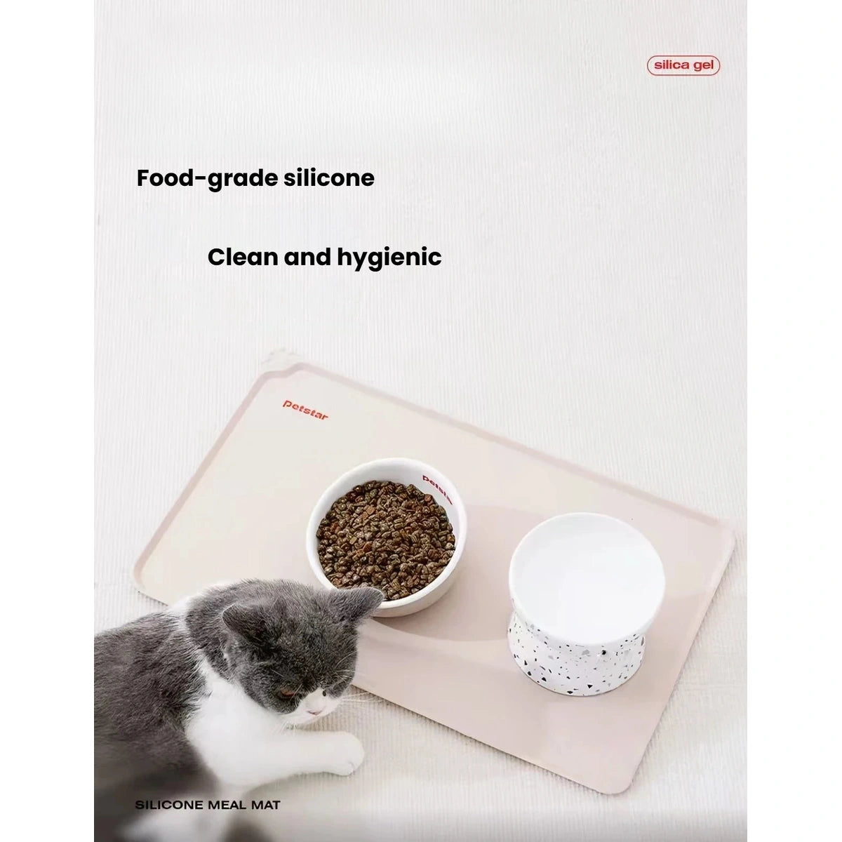 Cat beside a bowl on the wipe-clean silicone feeding mat