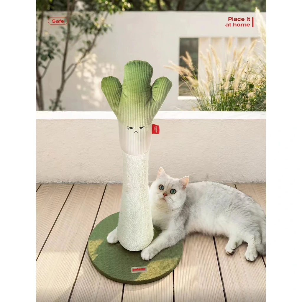 Cat resting beside the green onion cat tree