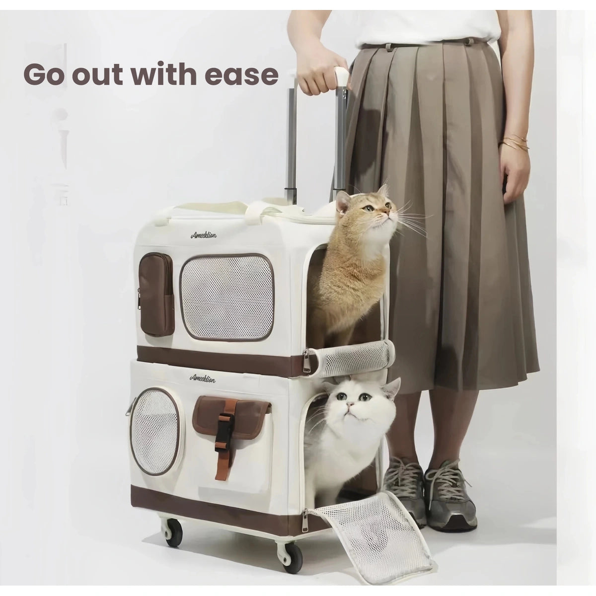 Person pulling the double-layer cat carrier beside two cats